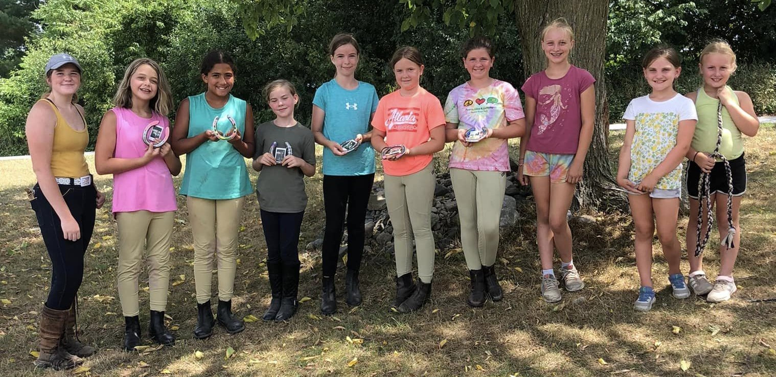 group of campers displaying their arts and crafts project